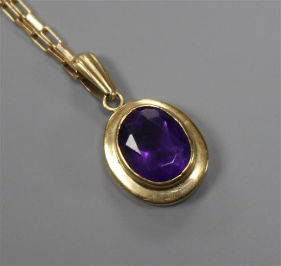 A modern 9ct gold and amethyst drop pendant on a 9ct gold chain, pendant 14mm.